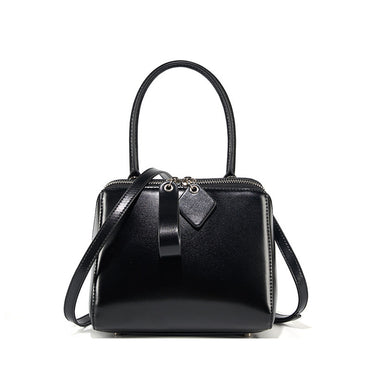 Black handbag with a strap on a white background