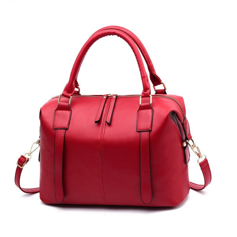 Red handbag with gold accents on a white background