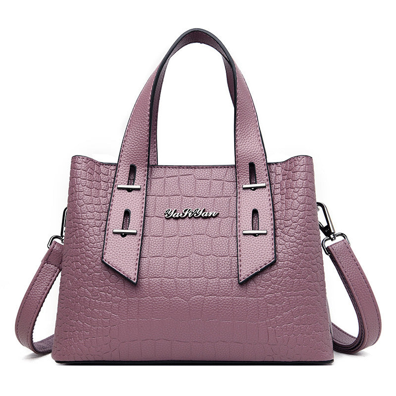 Purple handbag with a visible brand logo on a white background