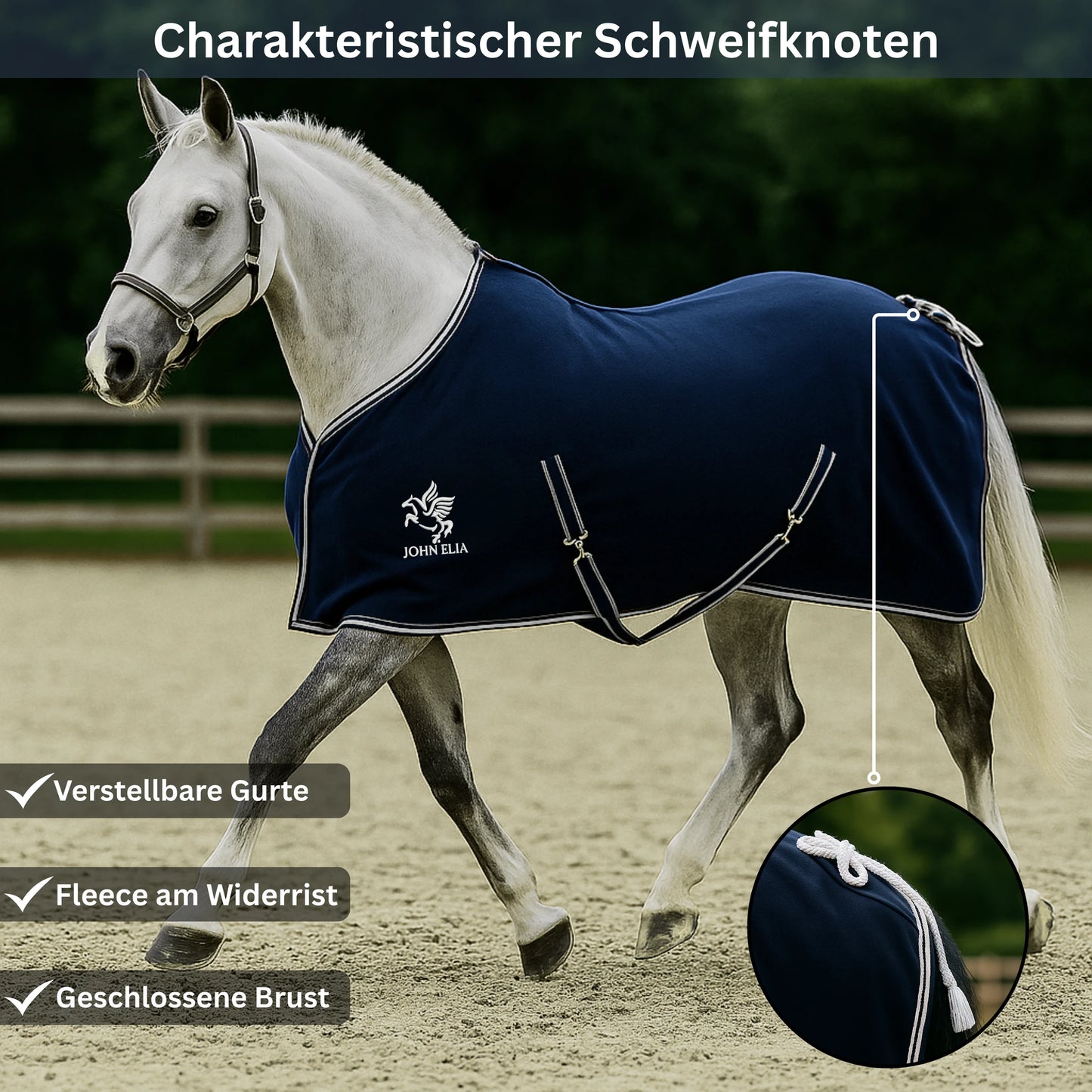 White horse wearing a navy blue rug with John Ella logo in an outdoor setting