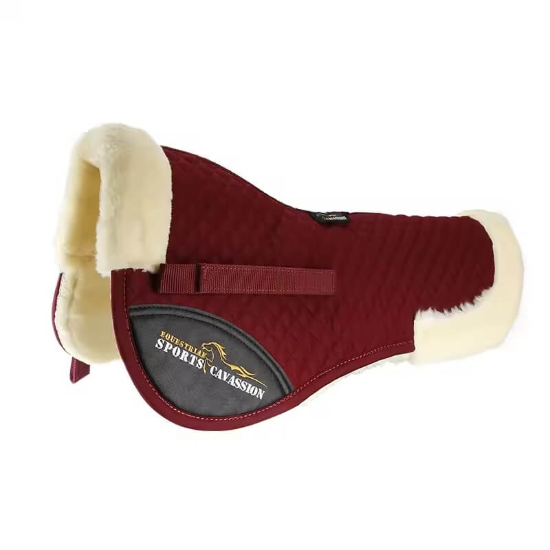 Red horse saddle pad with cream fur on a white background